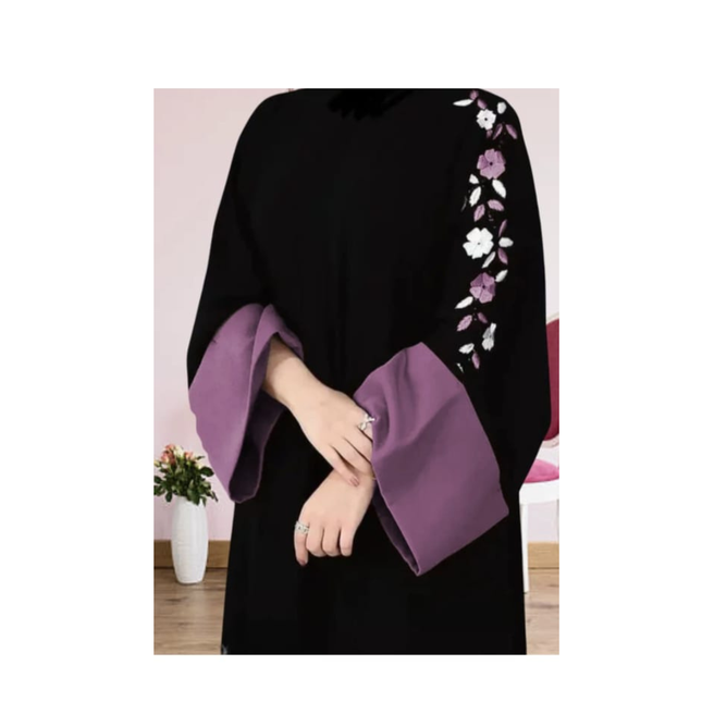Black and purple garment with floral embroidery on a white background