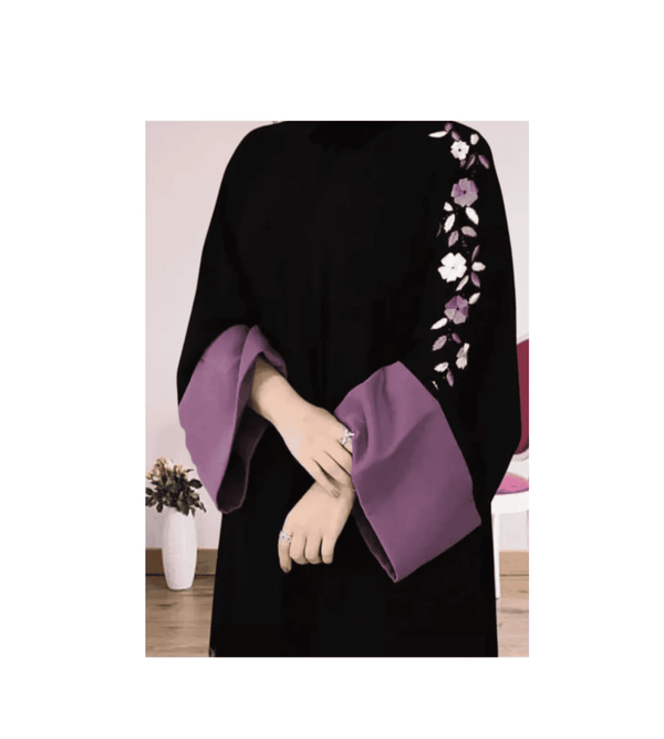 Black and purple garment with floral embroidery on a white background