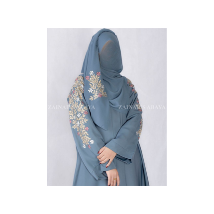 Blue abaya with floral embroidery on a white background