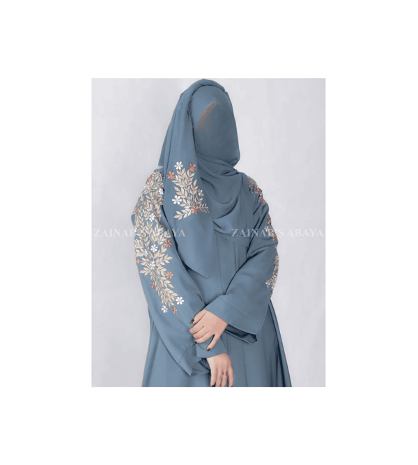 Blue abaya with floral embroidery on a white background