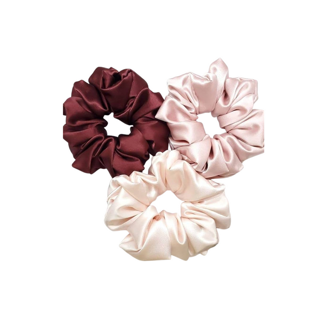 Three satin scrunchies in maroon, pink, and beige on a white background