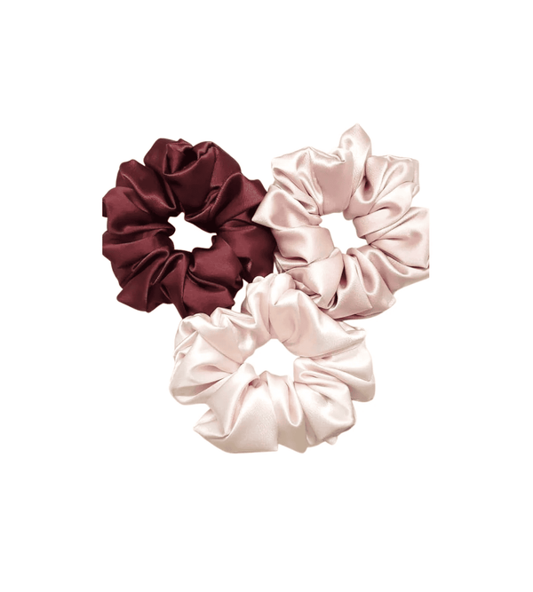 Three satin scrunchies in maroon, pink, and beige on a white background