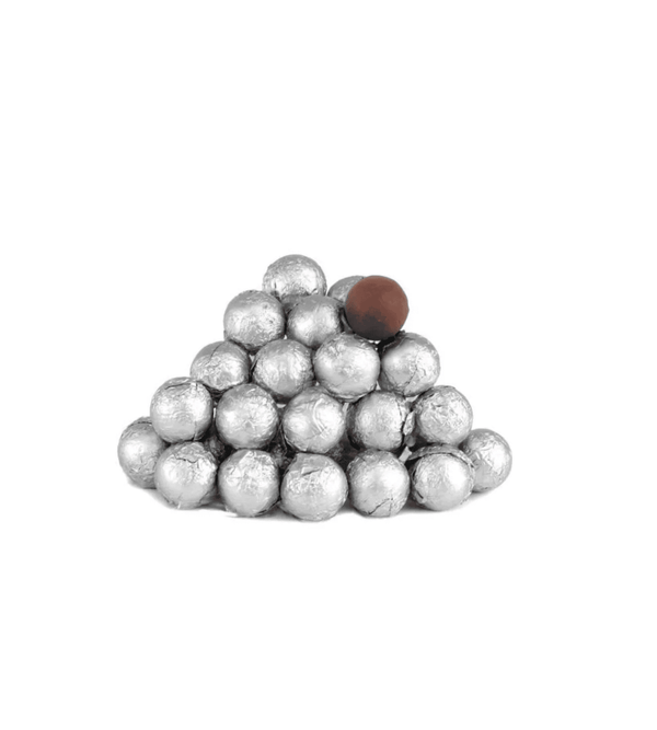 Pyramid of silver balls with a single brown ball on a white background