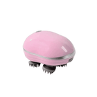 Pink handheld massager on a white background