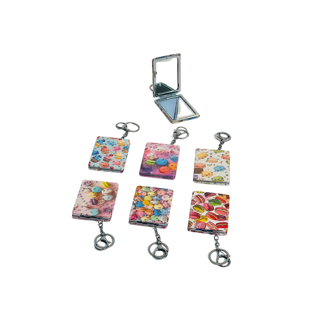 Set of colorful keychains with a compact mirror on a white background