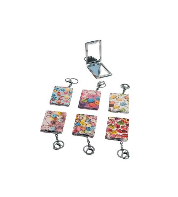 Set of colorful keychains with a compact mirror on a white background