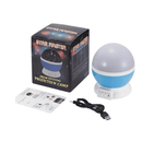 Star Master projection lamp with packaging, USB cable, and user manual on a white background