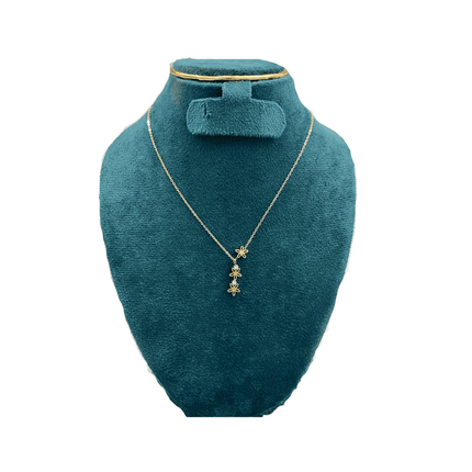 Gold necklace with star pendant on a teal mannequin bust against a white background