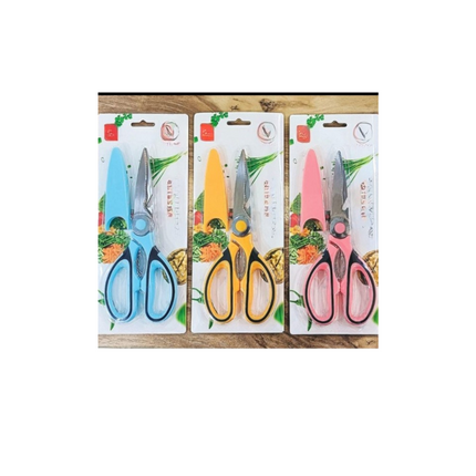 Three pairs of scissors in different colors with packaging on a wooden surface.