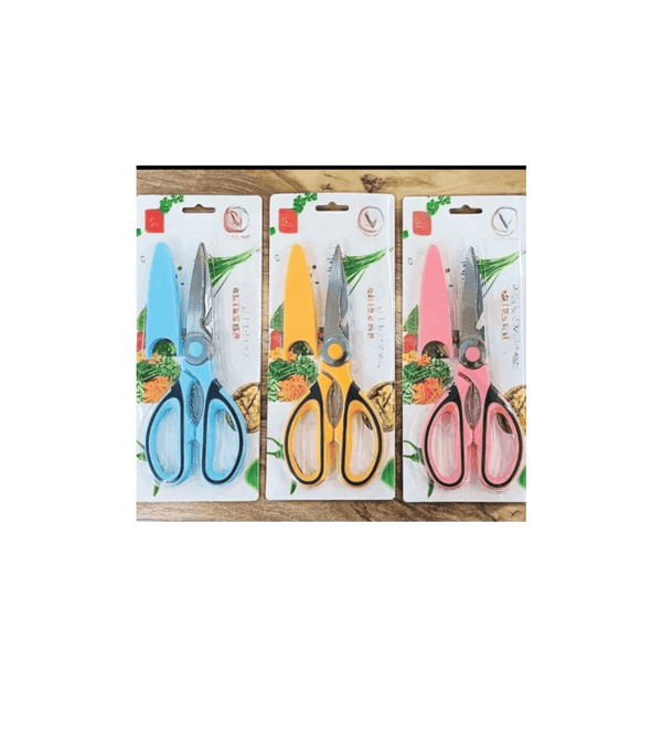Three pairs of scissors in different colors with packaging on a wooden surface.