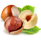 Three hazelnuts with green leaves on a white background