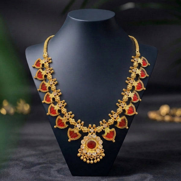 Gold necklace with red stones on a black mannequin bust