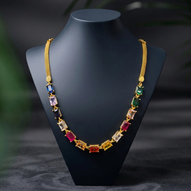 Multicolored gemstone necklace on a black mannequin bust against a dark background