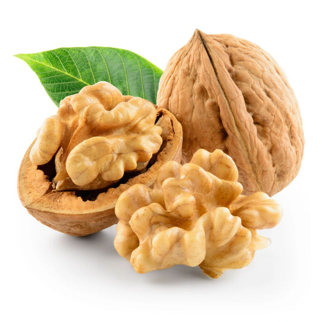 Three walnuts with a green leaf on a white background