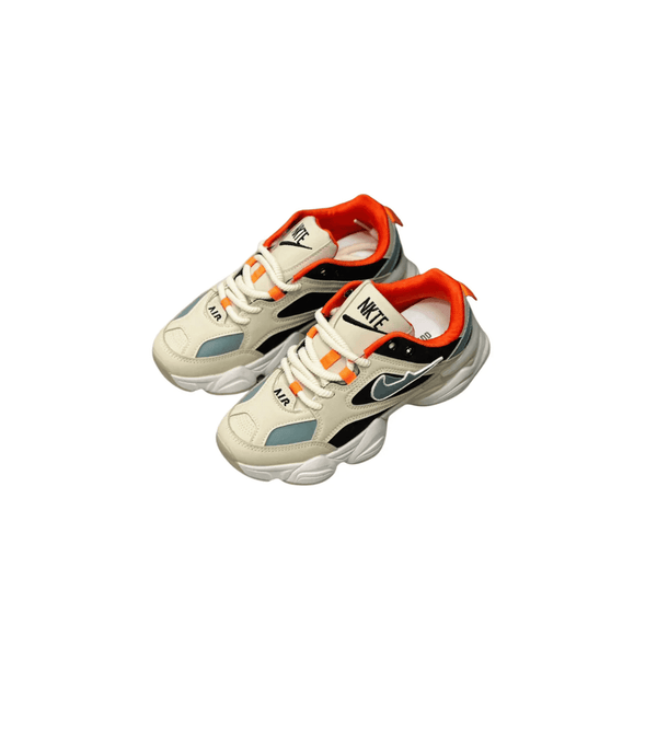 Pair of beige sneakers with orange and black accents on a white background