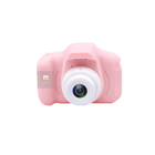 Pink toy camera on a white background
