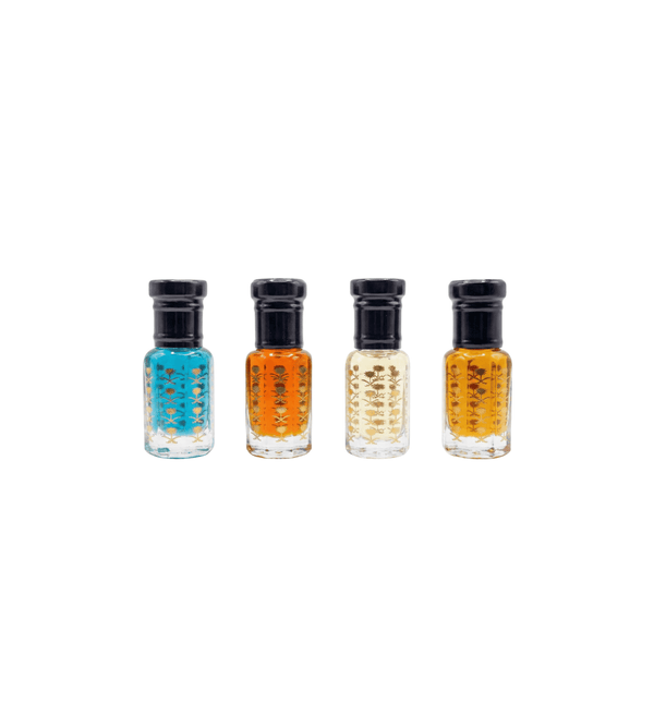 Four small bottles of nail polish in different colors on a white background