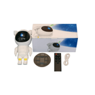 Toy robot in astronaut suit with packaging, remote control, and power plug on a white background