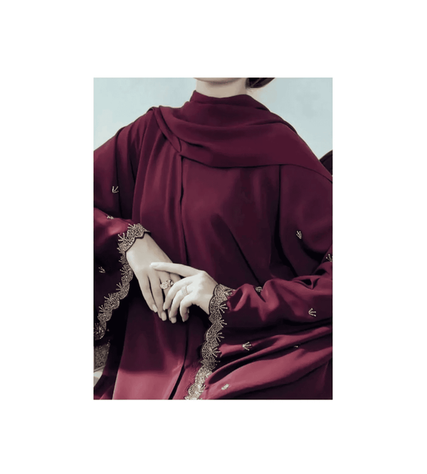 Maroon abaya with intricate detailing on a light gray background