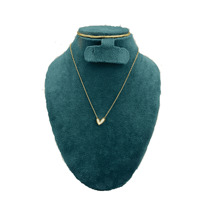 Gold necklace on a green velvet mannequin bust with a white background